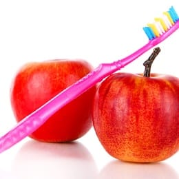 Two apples and a toothbrush