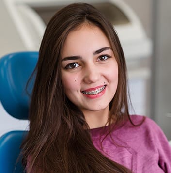 Teen girl with braces in dental chair