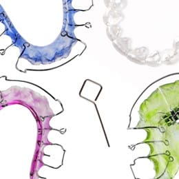 Colored orthodontic retainers on a white background