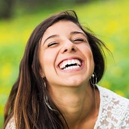 Laughing young woman outdoors