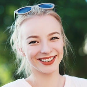 Young woman with tooth-colored braces