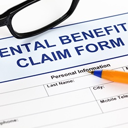 an empty dental insurance claims form with a pen on top of it