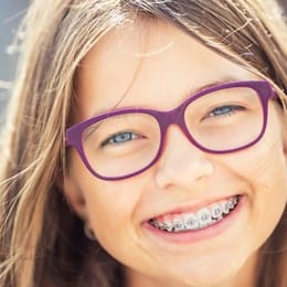 A young girl smiling with braces