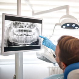 an orthodontist showing a patient their x-rays