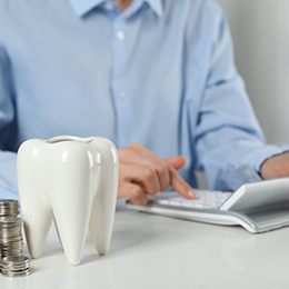 A patient calculating the cost of treating an orthodontic emergency 