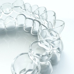 An up-close look at the top and bottom Invisalign aligners used to straighten a patient’s smile