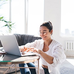 Woman smiling while working at home