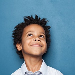 Smiling young boy looking upward