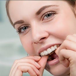 Young woman placing her orthodontic appliance