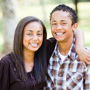 Teen girl and boy with braces