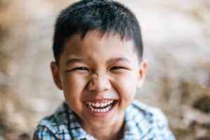 Young boy smiling while looking at the camera