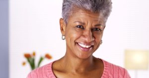 Older woman smiling after orthodontics