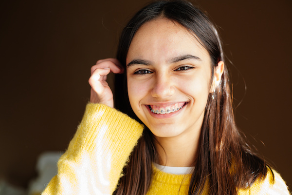 happy young woman smiling with braces