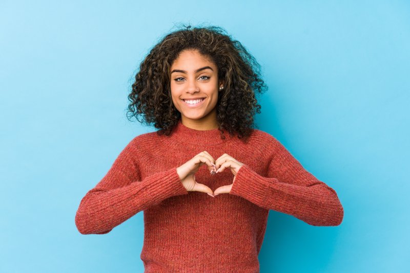 woman making heart with hands