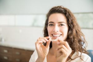 Woman holding clear aligner