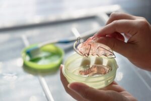 Person putting their retainer in their case